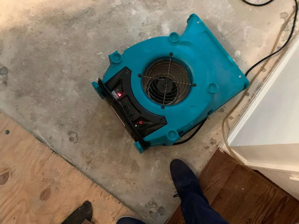 Air mover drying subfloor during Commercial Water Damage Restoration in Sioux Center